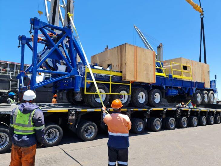 Workers preparing the huge vehicle to the transport