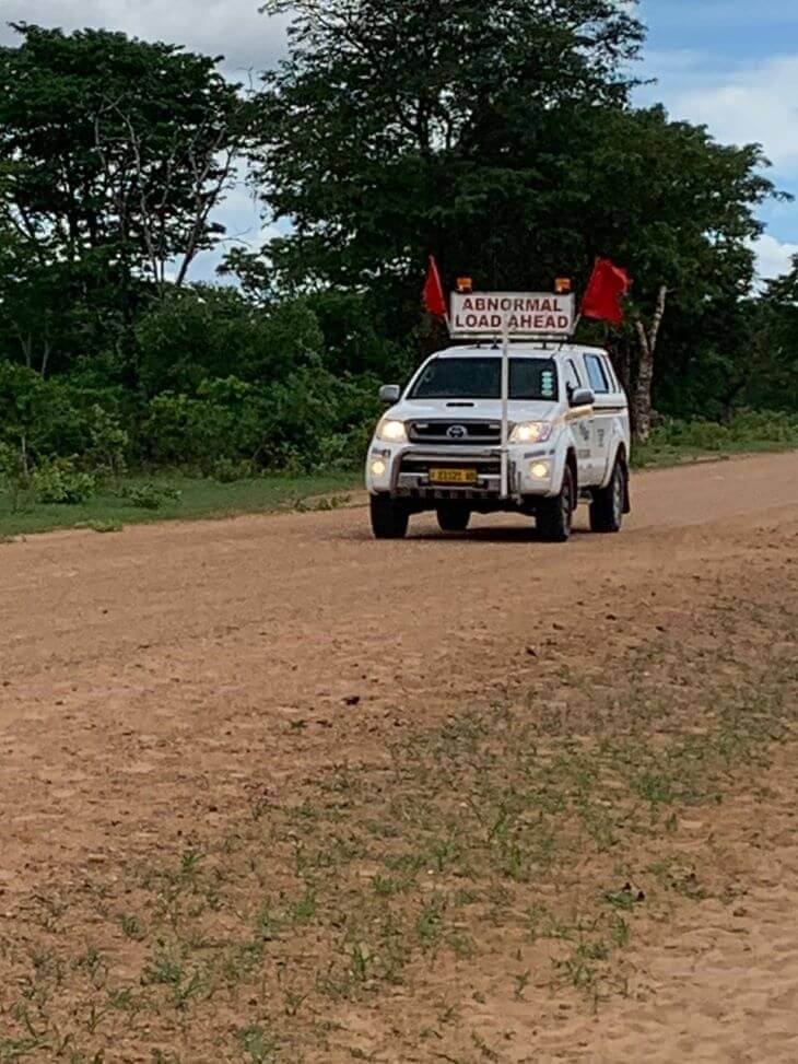 A car piloting a large transport