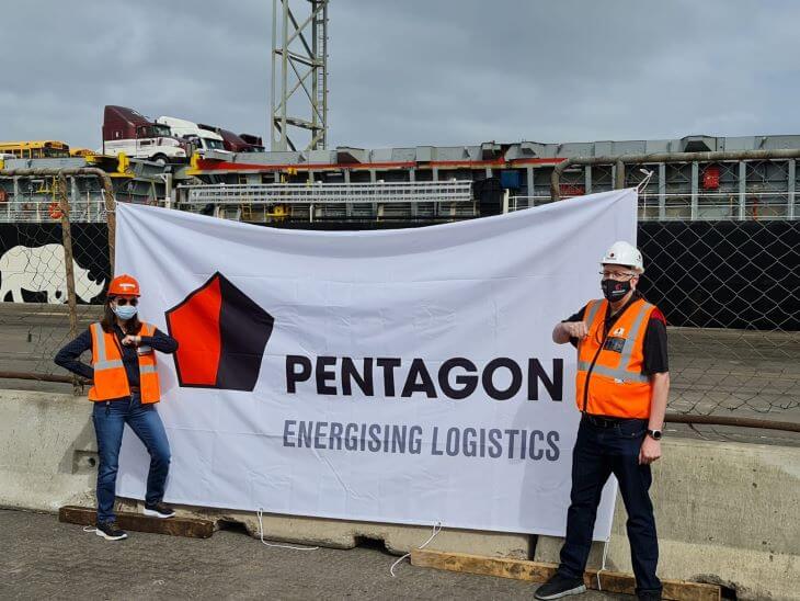 Two workers in helmets on the background of a Pentagon company image banner