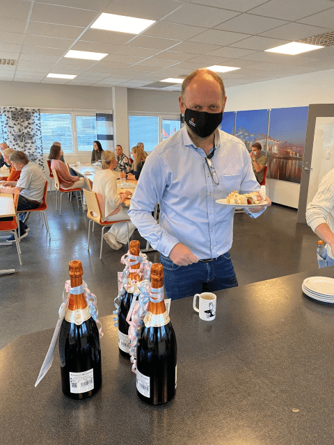 Men in a protective mask with a piece of cake