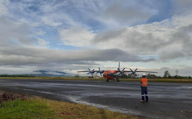 Airport worker looking at the plane