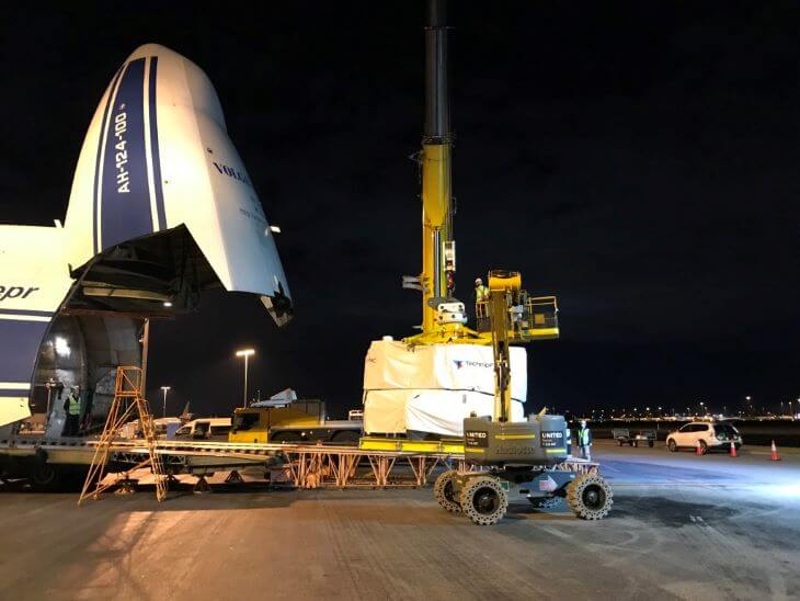 A large cargo is lifted from the plane