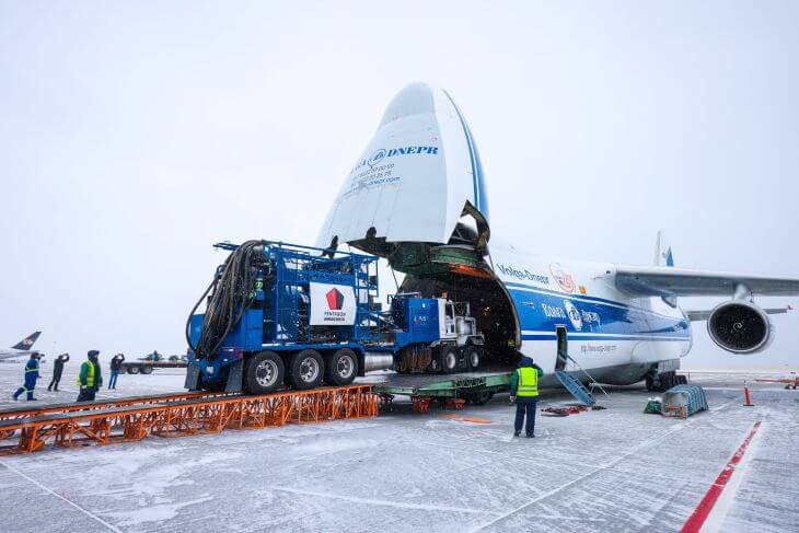 A heavy equipment truck driving onto the transport plane