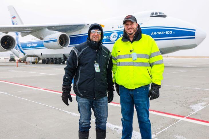 Two men on the background of an airplane