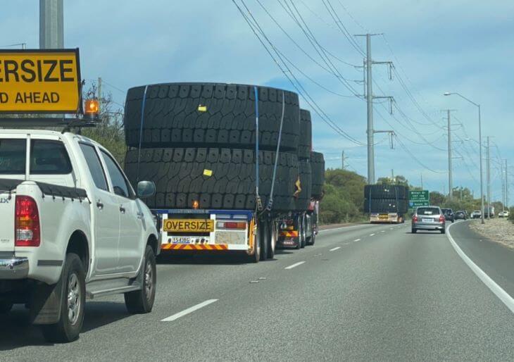 Transport of giant tires in escort of special vehicles