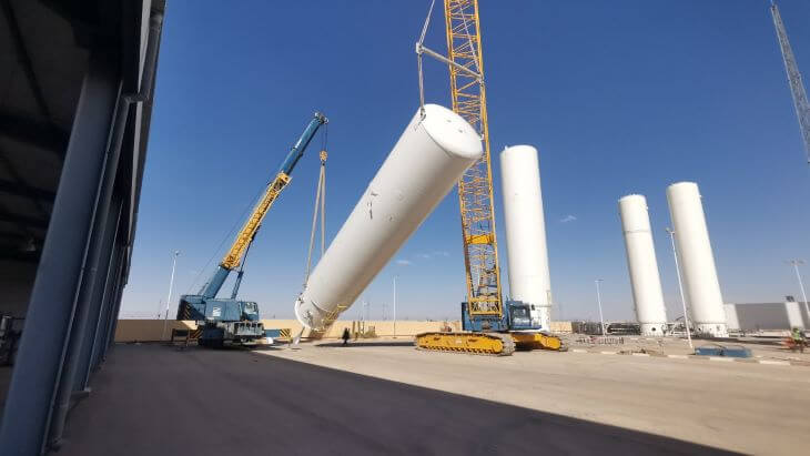 The crane prepares the storage tanks for transport