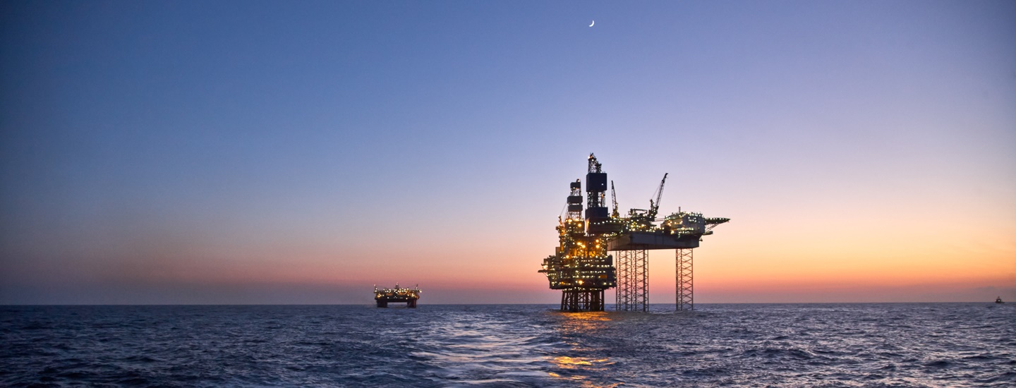 A huge platform at sea during sunset