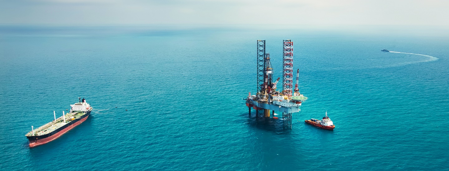 Ships next to a huge platform at sea