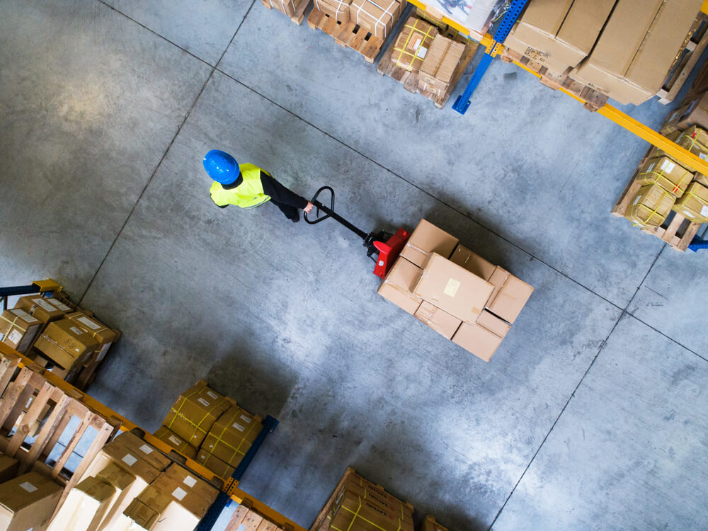 The warehouseman transports cardboard boxes