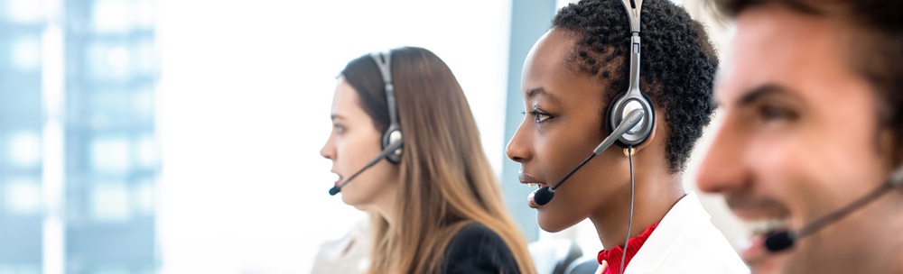 3 employees with headphones