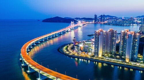 The illuminated road over the bay in the city of Busan